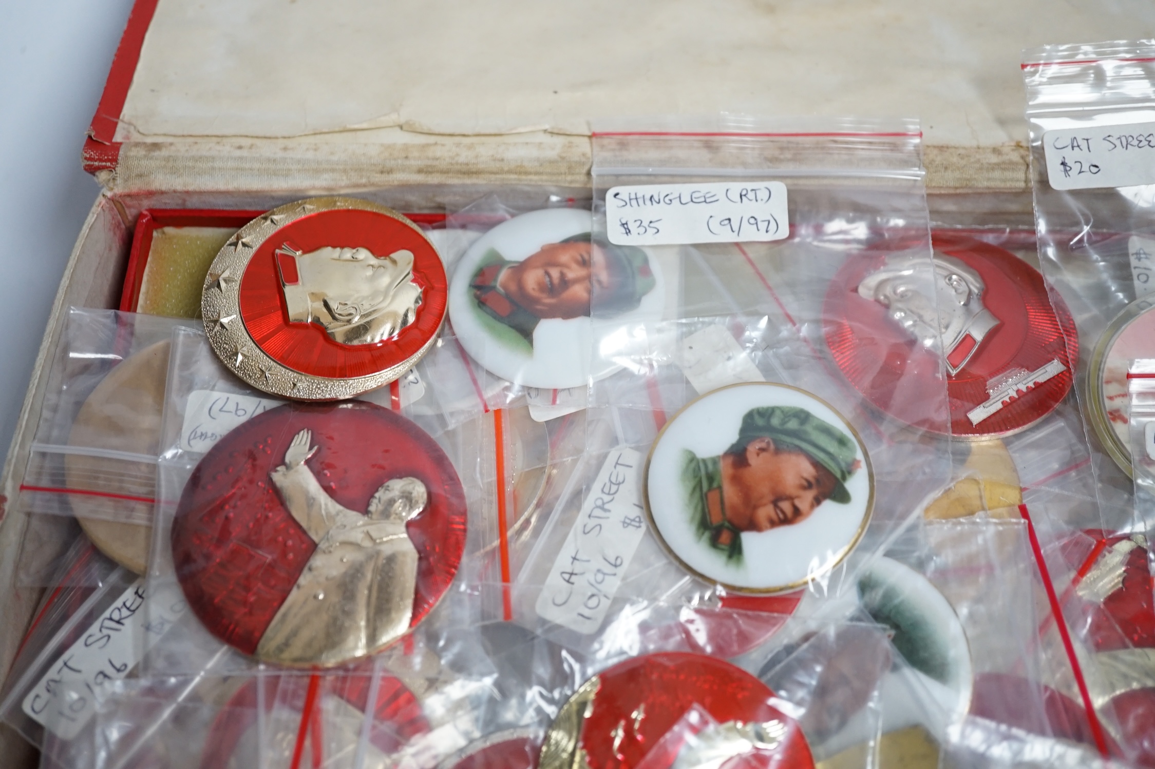 A collection of forty one Chinese Mao Zedong badges and a box